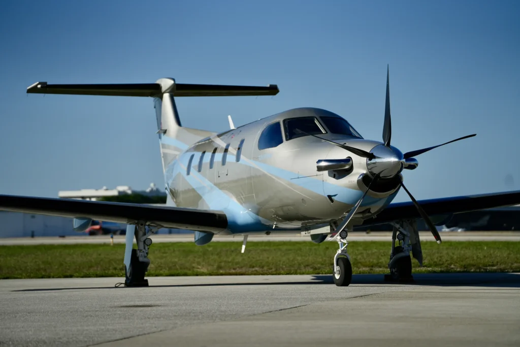 Front view of a Pilatus PC12 NGX parked on the tarmac under clear skies.