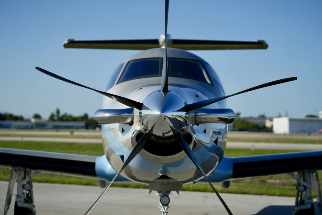 Close-up head-on view of the propeller and cockpit of a Pilatus PC12 NGX.