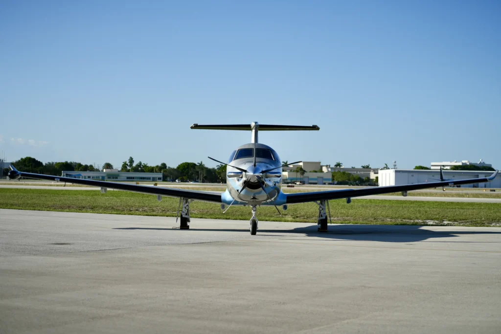 Full frontal shot of a Pilatus PC12 NGX on the runway with extended wings.