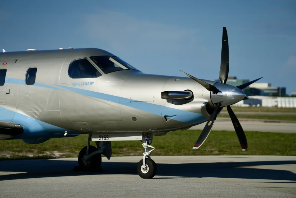Side-front view of a Pilatus PC12 NGX highlighting cockpit and propeller.