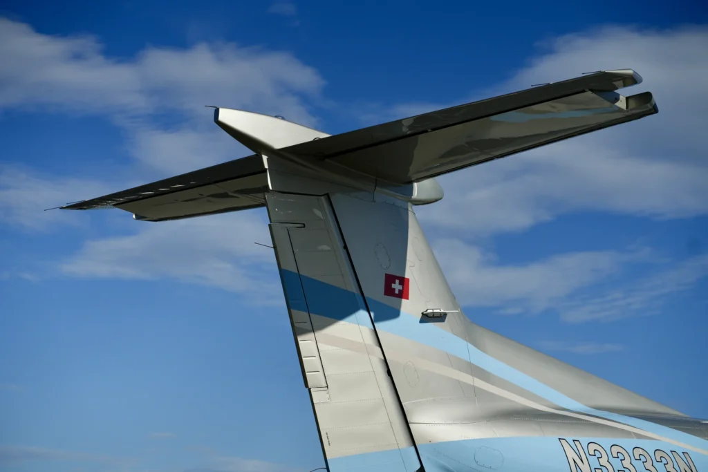 Detailed view of the tail section of a Pilatus PC12 NGX with Swiss flag.
