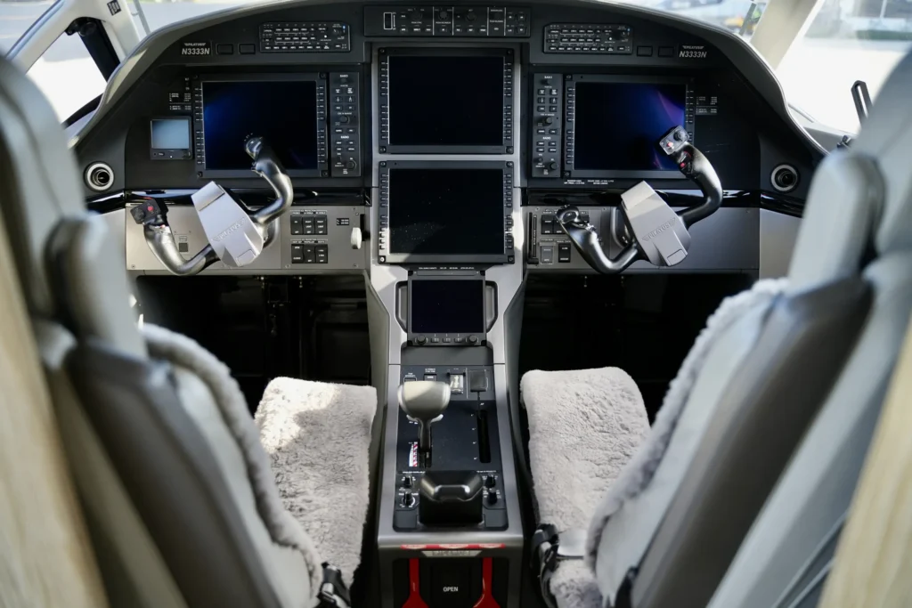 Cockpit view of a Pilatus PC12 NGX with modern avionics and dual controls.