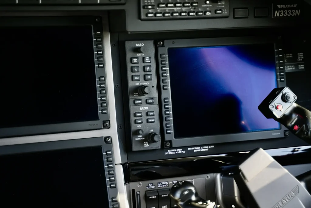 Detailed view of avionics screens and control panels in a Pilatus PC12 NGX cockpit.