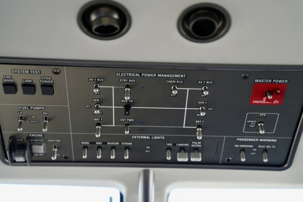 Overhead panel of a Pilatus PC12 NGX showing electrical and system controls.