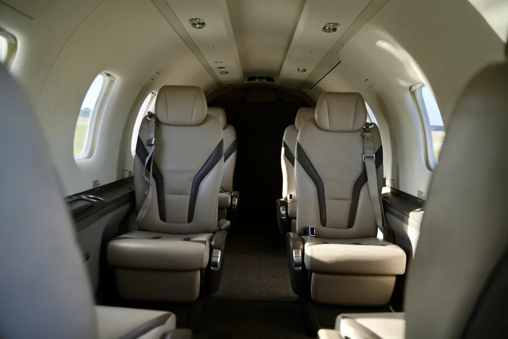 Cabin interior of a Pilatus PC12 NGX with beige leather passenger seats.