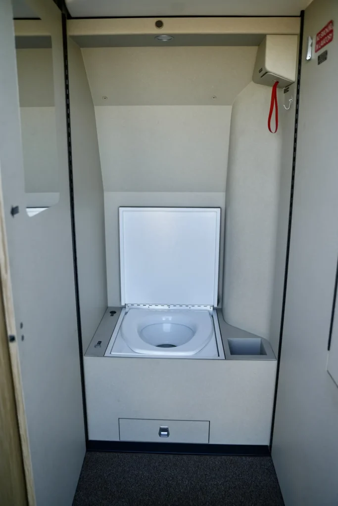 Compact lavatory with fold-out toilet inside a Pilatus PC12 NGX.